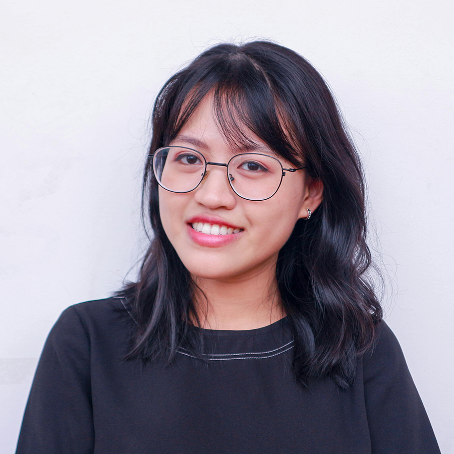 woman with glasses smiling